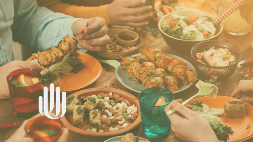 close up on plates of food, hands of people eating.