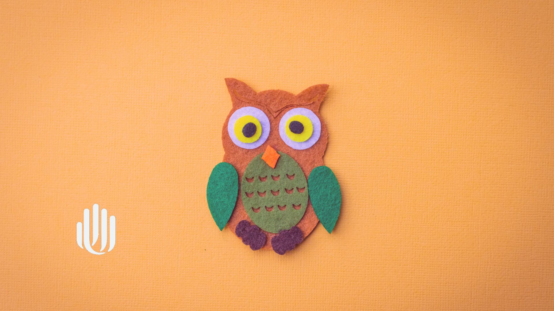 colourful felt owl on an orange background
