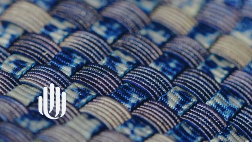 close-up of blue and tan woven material with UU logo.