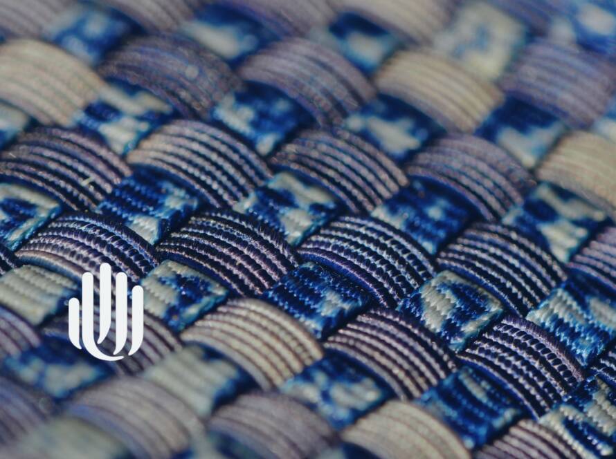 close-up of blue and tan woven material with UU logo.