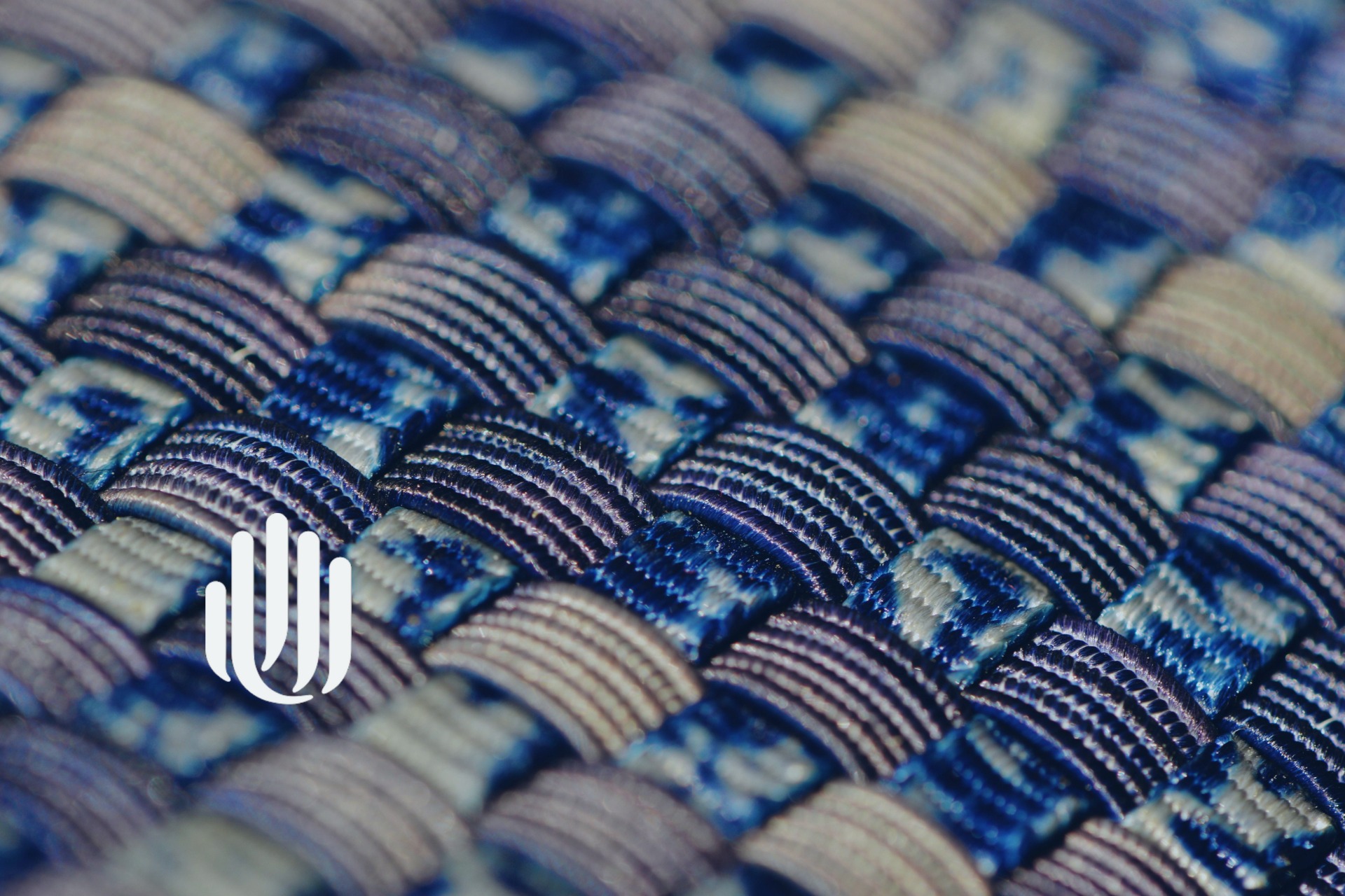 close-up of blue and tan woven material with UU logo.